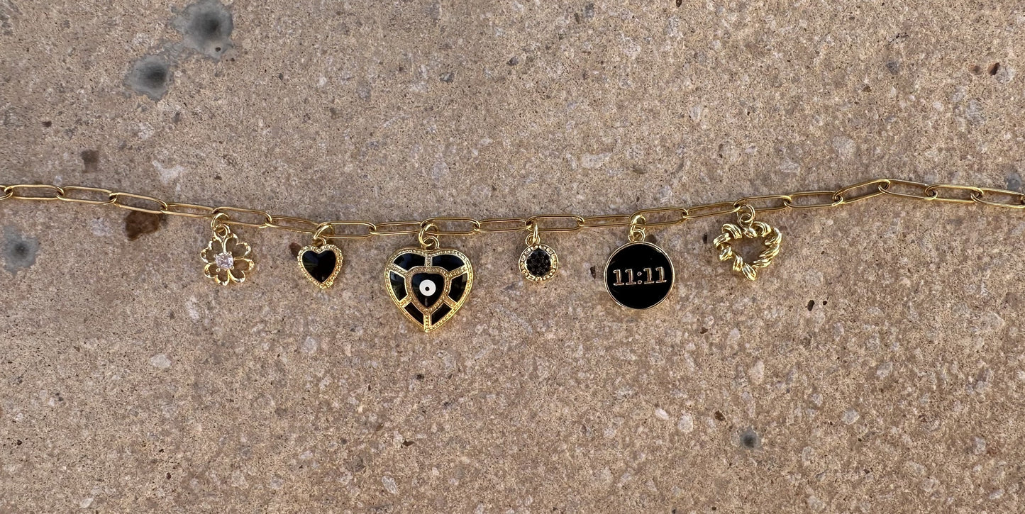Black 11:11 luck and angel number charm with gold border, perfect for DIY custom jewelry and unique creations.