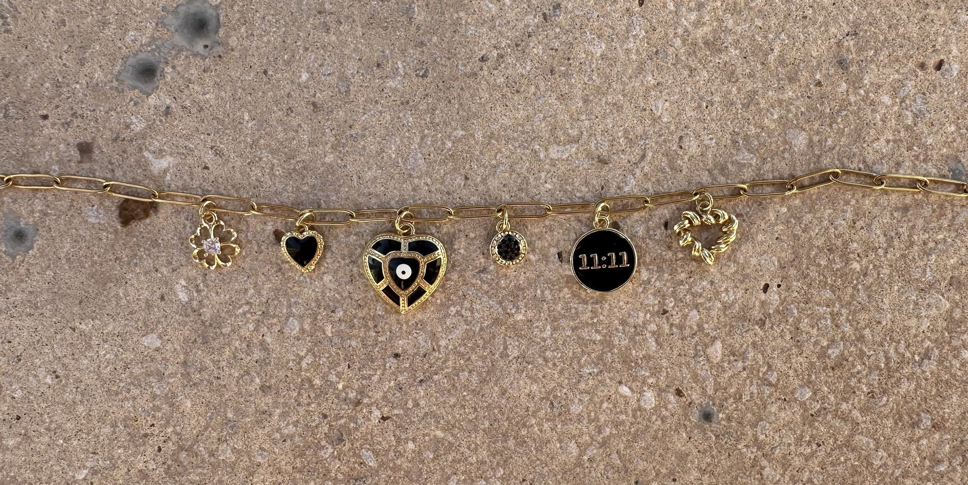Black 11:11 luck and angel number charm with gold border, perfect for DIY custom jewelry and unique creations.