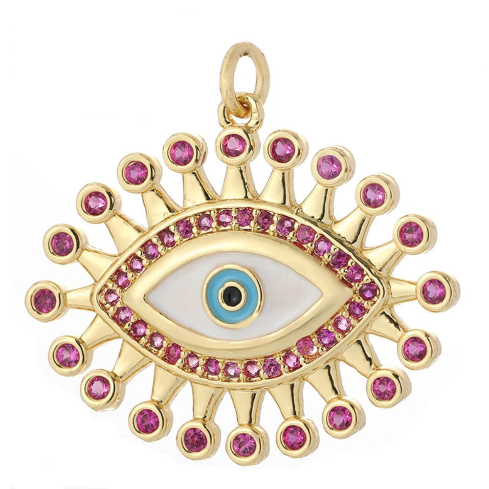 A Thousand Views golden charm with mother-of-pearl evil eye and pink gemstone sunburst, inspired by Arabian Nights