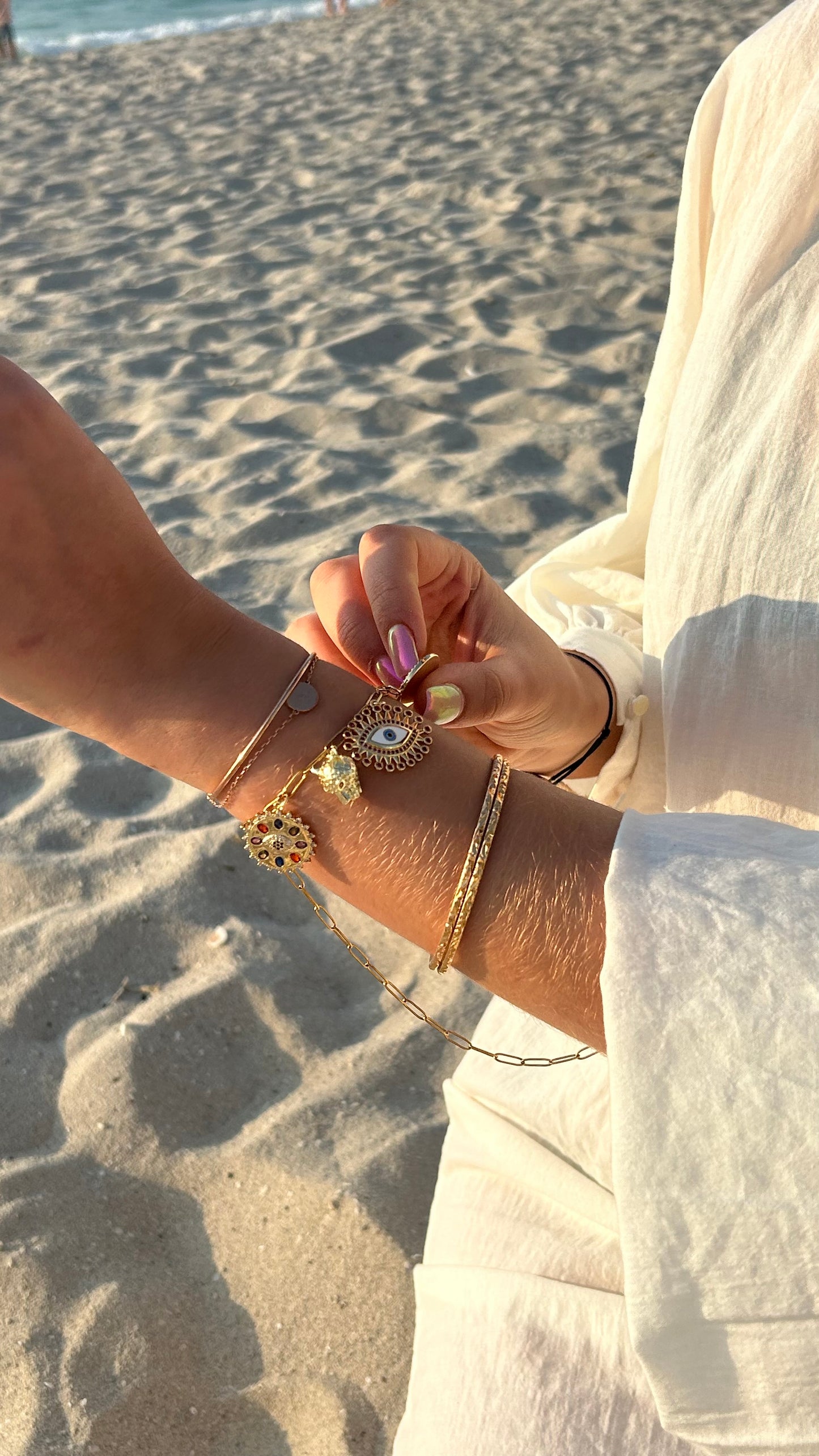 Gold-tone Arabian Nights bracelet adorned with charms for personalized jewelry